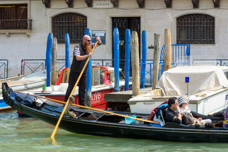 Venice, Italy - May 18, 2017: Gondola sails on the Grand Canal in Venice. Gondola is a most attractive tourist transport of Venice. Romantic water trip across Venice in summer.のeditorial素材