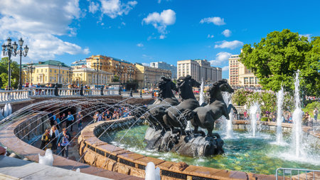 Moscow â May 19, 2019: People walk on Manezhnaya Square in Moscow, Russia. It is a tourist attraction of Moscow. Panorama of beautiful fountains in summer. Concept of travel and vacation in Moscow.のeditorial素材