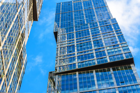 Moscow - Sep 10, 2017: Modern skyscrapers in Moscow-City, Russia. Sky and buildings reflected in facade. Moscow-City is a district with business and residential towers. Urban architecture of Moscow.のeditorial素材