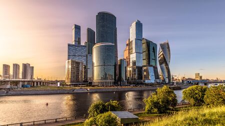 Moscow-City skyscrapers at sunset, Russia. Moscow-City is modern business district at Moskva River. Panoramic view of tall buildings in the Moscow center. Urban landscape of Moscow in summer evening.の写真素材