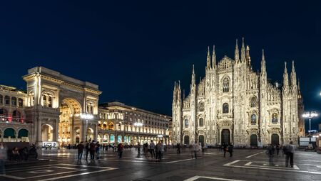 Milan Cathedral or Duomo di Milano at night, Italy. This place is a top landmark of the Milan. Panorama of the famous Milan city center at dusk. Long exposure of main Milan square with blurred people.の写真素材