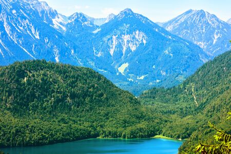 Landscape of Alpine mounts, Germany. Beautiful scenery of Alps with snowy peaks in summer. Mountain landscape with nice lake in forest. Scenic view of nature in Bavaria. Hike and trekking concept.の写真素材