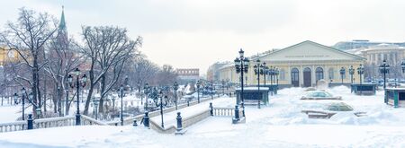 Moscow in winter, Russia. Snowy Alexander Garden and Manezhnaya Square near Moscow Kremlin. Panoramic view of the Moscow city center during snowfall. Scenery of old Moscow buildings under snow.の写真素材