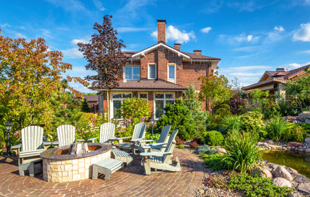Moscow Region - Aug 24, 2019: Landscape design of home garden. Beautiful landscaping with small pond. Scenery of landscaped place with patio in summer. Nice landscaping in luxury backyard of house.のeditorial素材