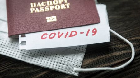 Coronavirus and travel concept. Note COVID-19 coronavirus, passport and mask.