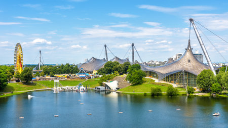 Munich Olympiapark in summer, Germany. It is the  Park, landmark of Munich. Scenic view of former sport area. Panorama of the green Munich district with lake. Beautiful skyline of Munich city.のeditorial素材