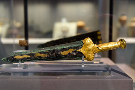 Athens - May 7, 2018: Bronze sword with gold hilt revetment from Greek Mycenae (Mykines) in National Archaeological Museum of Athens, Greece. Steel arms, jewelry and history of ancient civilization.のeditorial素材