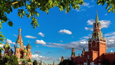 Moscow cityscape in summer, Russia. Panorama of Red Square in Moscow city center, beautiful view of St Basil's Cathedral and Kremlin through foliage. This old place is famous landmark of Moscow.の写真素材