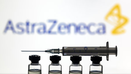 Moscow - Jan 5, 2021: Astrazeneca COVID-19 vaccine concept. Syringe and bottles with US vaccine for coronavirus on logo background. Corona virus drug, injection and medical shot during COVID pandemicのeditorial素材