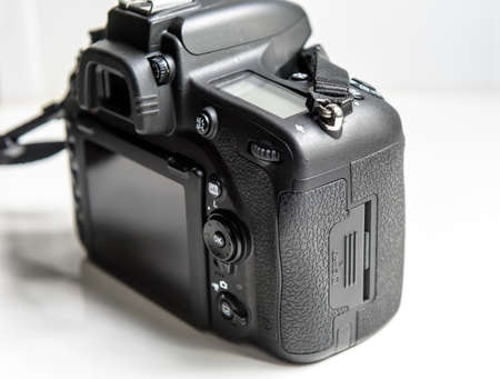 Photo camera on white background, back and side view of professional DSLR camera body, card block,...