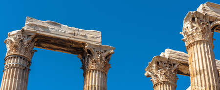 Ancient Temple of Olympian Zeus, Athens, Greece. Panoramic view of Corinthian columns on blue sky background. Classical Greek building of Zeus is famous landmark of Athens, monument of old history.の写真素材