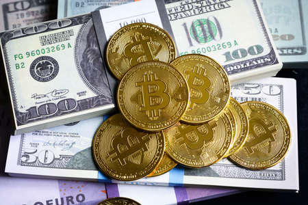 Bitcoin and money stacks, digital virtual crypto currency bitcoin btc with cash pile. Much of euro...
