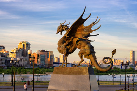 Kazan, Russia - June 18, 2021: Statue of Dragon Zilant at Wedding palace (Family center) in Kazan, Tatarstan. This place is tourist attraction of city. Kazan cityscape at sunset. Travel concept.のeditorial素材