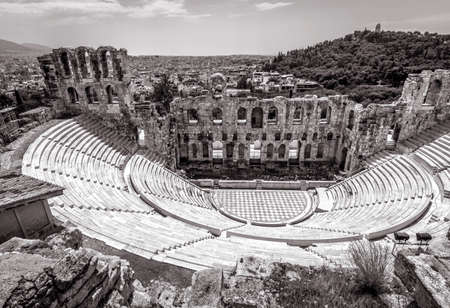 Odeon of Herodes Atticus at Acropolis of Athens, Greece. Classical Greek theater overlooking Athens city. It is one of top landmarks of Athens. View of Ancient ruins in black and white. Vintage photoの写真素材