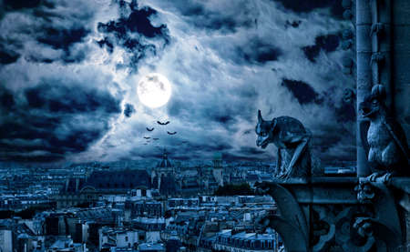 Paris at gothic night on Halloween, France. Fantasy panorama of creepy city and gargoyle of Notre Dame cathedral, dark haunted city with full moon and bats in dramatic sky. Scary scene and horror.の写真素材