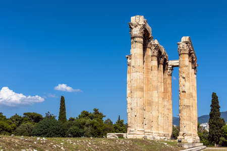 Temple of Olympian Zeus in Athens, Greece. Landscape with ancient Greek ruins in summer. This place is landmark of Athens. Scenic view of old great columns on blue sky background in Athens center.の写真素材