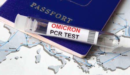 Omicron COVID-19 variant, travel and test concept, tube for corona virus PCR testing and tourist passport on Europe map. Coronavirus diagnostics in airport due to new restrictions and lockdown.の写真素材