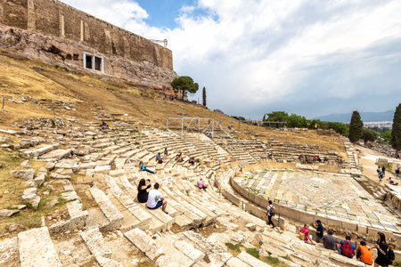 Athens - May 8, 2018: Theater of Dionysus and famous Acropolis in distance, Athens, Greece, Europe....