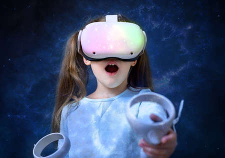 Kid using virtual reality headset, cute child looking in VR glasses. Young person with futuristic...