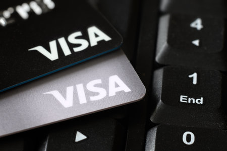 Moscow - March 6, 2022: Visa credit cards on keyboard for online purchase and transaction. Plastic cards on laptop close-up. Concept of payment, sell, internet search, electronic money and security.のeditorial素材