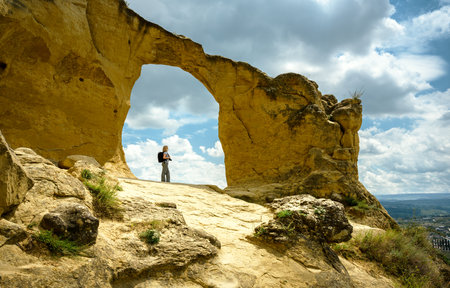 Mountain Ring in Kislovodsk, Stavropol Krai, Russia. Landscape of picturesque rock in summer, view of person against sky. Concept of nature, travel people, hike, freedom and tourism in Caucasus.の写真素材