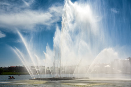 Fountain on blue sky background, Kazan, Tatarstan, Russia. Scenic view of big nice waterfall in Kaban Lakes in summer. It is a tourist attraction of the city. Theme of water, freshness, weather, season.の写真素材