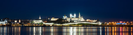 Kazan Kremlin by river at night, Tatarstan, Russia. Panorama of old white fortress, main landmark of Kazan. View of Kazan city center and reflections in water.の写真素材