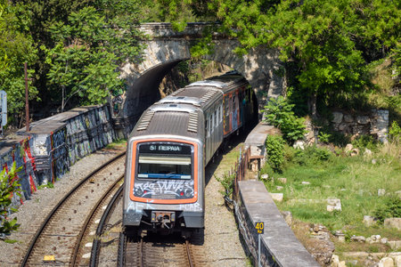 Athens - May 9, 2018: Subway train moves in summer outdoor, Athens, Greece, Europe. Railroad cars...