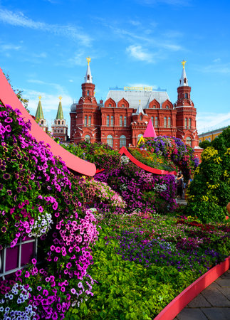 Flower Festival in central Moscow in summer, Russia. Historical Museum in background, old Moscow landmark. Scenery of beautiful floral decorations in Moscow city. Travel, bloom, sightseeing theme.のeditorial素材
