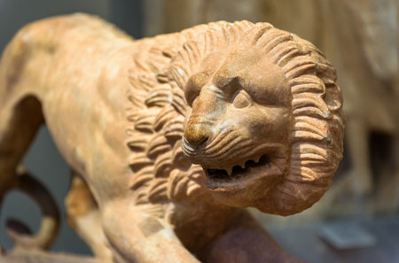Stone statue of lion, ancient Greek sculpture of animal, marble ferocious lion close-up. Theme of culture, antique, art, civilization.のeditorial素材