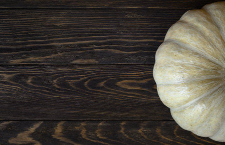 Vintage wood texture background for Halloween theme, top view. Dark brown wooden planks and white pumpkin, vegetable ripe. Hallowen, thanksgiving, food, squash and autumn concept.の写真素材