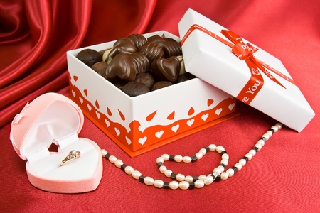 Opened box of chocolate, gold ring in the box and jevelry.の写真素材