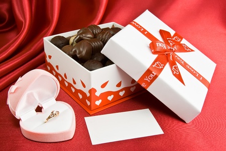 Box of chocolate and a gold ring in the box.の写真素材