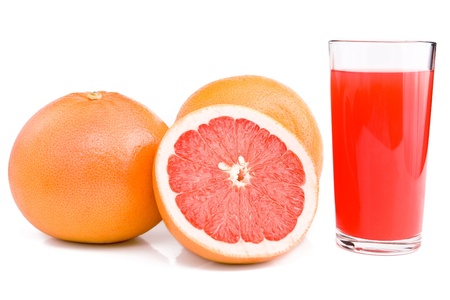 Grapefruits and glass of juice are isolated on the white. Cut of grapefruit.の写真素材