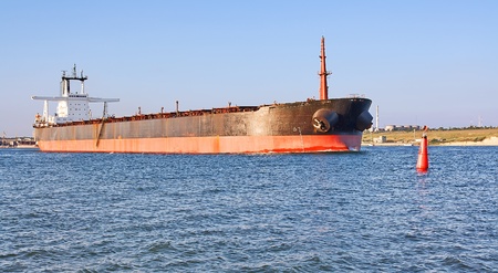 A big cargo ship and buoy in the harbour.の写真素材