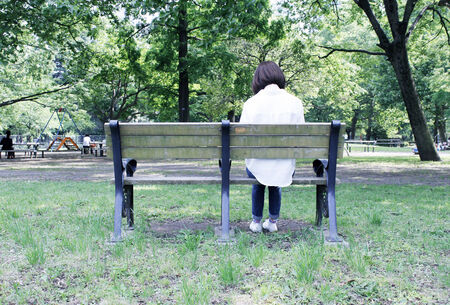 A woman reading in the parkの写真素材