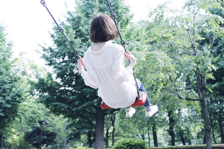 Woman riding a swingの写真素材