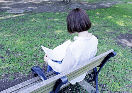 Woman sitting on a benchの写真素材