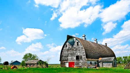 An old abandoned barn sits decaying on an empty farm in northern Minnesota.の写真素材