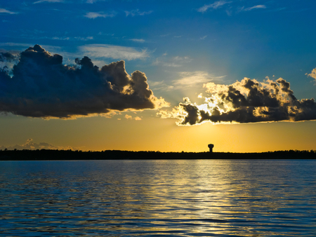 Dramatic clouds and sunset over Lake Irving in Bemidji Minnesotaの写真素材