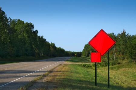 Orange Warning Road Signs on highway at construction site on sunny morning. ADD YOUR TEXTの写真素材