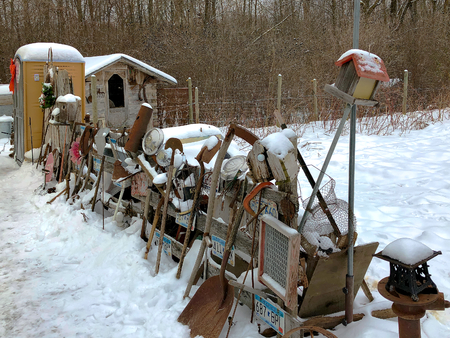 Old rusty broken junk for sale on display in snowy northern Minnesota in December.