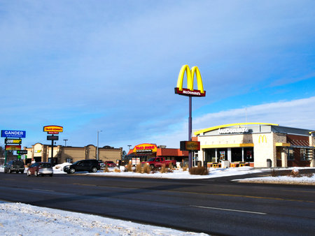 BEMIDJI, MN - 24 DEC 2018: Street view with McDonalds restaurant and arches and other stores in winter. McDonalds is the worlds largest restaurant chain.のeditorial素材