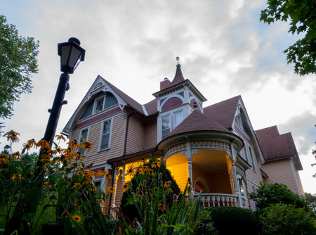 LANESBORO, MN - 25 AUG 2019: The Scandinavian Inn, a Victorian style Bed and Breakfast after sunset and flowers in garden, at dusk.のeditorial素材
