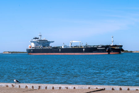 PORT ARANSAS, TX - 1 FEB 2020: The ARGIRONISSOS, a Crude Oil Tanker ship, is sailing on the shipping channel between Corpus Christi, Texas and the Gulf of Mexico with a pilot boat following.のeditorial素材
