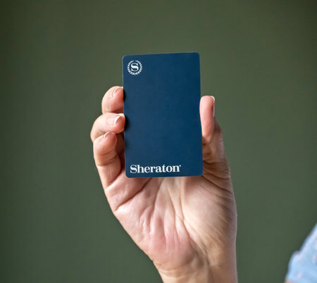 BEMIDJI, MN - 20 JUL 2020: Womans hand holding room security keycard for Sheraton Hotels in close-up view.のeditorial素材