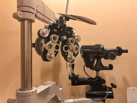 Close up of a phoropter in an eye doctors office with typical muted lighting.の写真素材