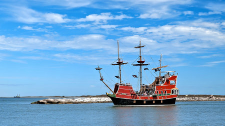PORT ARANSAS, TX - 29 FEB 2020: The Red Dragon Pirate Cruise, a tourist excursion boat with passengers and entertaining crew, leaves the marina.のeditorial素材
