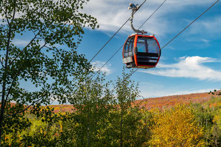 Cable car on a cable passes by nearby trees at a ski hill in Minnesota.の写真素材
