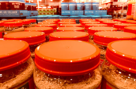 BAXTER, MN - 5 JAN 2022: Rows of orange jar lids on display in store.